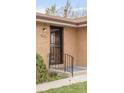 Close-up of the home's brick facade, showcasing the secure front door with a black metal security gate at 117 S Pierce St, Lakewood, CO 80226