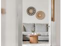 Stylishly decorated living room view featuring a neutral gray sofa and decorative wall art at 117 S Pierce St, Lakewood, CO 80226