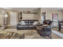 Cozy living room with dark leather furniture, decor, and views of other living spaces at 1177 Jamaica St, Aurora, CO 80010