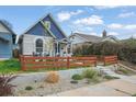 Beautiful home exterior with a new wooden fence and freshly landscaped front yard at 3317 W 37Th Ave, Denver, CO 80211