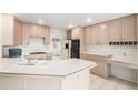 Bright kitchen with tile countertops, built-in appliances, ample cabinet space, and an adjacent desk area at 5485 S Jasper Ct, Centennial, CO 80015