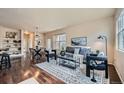 Cozy living room and dining area with hardwood floors, stylish furniture, and plenty of natural light at 11213 Colony Cir, Broomfield, CO 80021