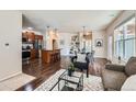 Inviting living space features a modern area rug, stylish seating, and an open kitchen at 11213 Colony Cir, Broomfield, CO 80021