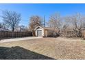 Exterior of house with a detached garage and grassy yard at 1453 Utica St, Denver, CO 80204