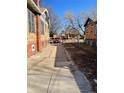 View of the side yard with a driveway and a red vehicle at 1453 Utica St, Denver, CO 80204