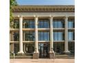 Elegant building exterior features large windows, ornate columns, and landscaping at 1210 E Colfax Ave # 104, Denver, CO 80218