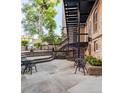 A beautiful outdoor patio features seating, stairs and lush landscaping at 1210 E Colfax Ave # 104, Denver, CO 80218