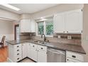 Well-maintained kitchen featuring stainless steel appliances, light countertops, and tiled backsplash at 4895 S Galapago St, Englewood, CO 80110