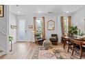 Inviting living room with hardwood floors, modern furnishings, and a bright open space to the dining area at 771 24Th St, Denver, CO 80205