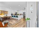 Bright and airy living space with modern finishes, a dining area, and an open kitchen with a large island at 771 24Th St, Denver, CO 80205