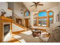 Bright living room with fireplace, hardwood floors, and high ceilings at 3891 Windchant Cir, Castle Rock, CO 80104