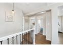 Bright hallway with hardwood floors leads to rooms, creating a welcoming and open atmosphere at 8074 Grove St, Westminster, CO 80031