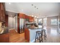 Open kitchen featuring cherry cabinets, granite countertops, and modern stainless steel appliances at 4225 W 30Th Ave, Denver, CO 80212
