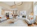 Open-concept living space with hardwood floors, stylish furniture, and seamless transition to the modern kitchen at 4193 W 99Th Ct, Westminster, CO 80031