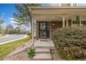 Close up of the front door with security screen and brick accents at 5316 S Jellison St, Littleton, CO 80123