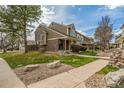 Inviting townhome with a well-manicured lawn and a cozy, covered porch at 5316 S Jellison St, Littleton, CO 80123