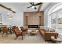 Bright living room with wood beams, modern fireplace and large windows showing the neighborhood outside at 512 W 8Th Ave, Denver, CO 80204