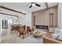 Open living room features a fireplace, modern ceiling fan and beams, and is open to the kitchen at 512 W 8Th Ave, Denver, CO 80204