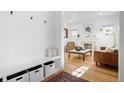 Bright entryway with built-in bench storage and view to living room at 1260 Adams St, Denver, CO 80206