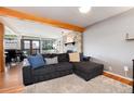 Living room featuring hardwood floors, a brick fireplace, and a large gray couch at 4545 S Lipan Ct, Englewood, CO 80110