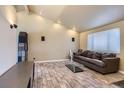 Bright living room featuring wood-look flooring, a modern fireplace, and large windows at 5738 W Canyon Ave, Littleton, CO 80128