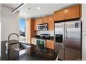 Bright kitchen features stainless steel appliances, granite counters, and stylish cabinets with a window view of the city at 891 14Th St # 2105, Denver, CO 80202