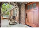 Welcoming front porch featuring rocking chairs and an inviting wood front door at 1278 Dexter St, Denver, CO 80220