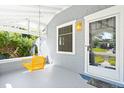 Inviting porch with a yellow porch swing, perfect for enjoying quiet mornings and afternoons at 4429 Winona Ct, Denver, CO 80212