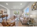Cozy living room with open floor plan to kitchen, featuring a large window and modern furnishings at 3200 N Elizabeth St, Denver, CO 80205