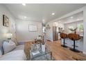 Open living area with wood floors seamlessly flows into the kitchen at 3200 N Elizabeth St, Denver, CO 80205