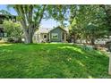 View of a home with a sprawling green lawn and mature trees at 1451 S Columbine St, Denver, CO 80210