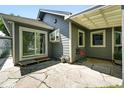 Outdoor patio area with stone flooring, a covered awning, and sliding glass doors at 1451 S Columbine St, Denver, CO 80210