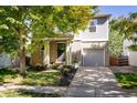 Inviting two-story home with a charming front yard, lush lawn, and a cozy entranceway at 3674 Dexter St, Denver, CO 80207