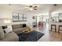 Open-concept living room featuring wood floors, comfortable seating, and abundant natural light at 3674 Dexter St, Denver, CO 80207