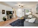 Cozy living room with a large sectional sofa, modern entertainment center, and stylish decor at 3674 Dexter St, Denver, CO 80207