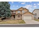 Charming two-story home with a three-car tandem garage and mature landscaping at 401 W Prestwick Way, Castle Rock, CO 80104