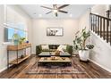 Cozy living room with a large window, comfortable green sofa, and a stylish rug and coffee table at 18077 E 99Th Ave, Commerce City, CO 80022