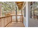 View of the wood porch overlooking the trees and surroundings at 30690 Highway 72, Golden, CO 80403