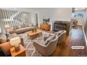 Virtually staged living room features a fireplace and hardwood floors at 2354 S Troy St, Aurora, CO 80014