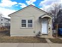 Exterior view of a cozy home featuring neutral siding, a covered entry, and classic architectural details at 914 La Farge Ave, Louisville, CO 80027