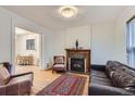 Bright living room featuring a fireplace, hardwood floors, and comfortable seating at 1474 Clayton St, Denver, CO 80206