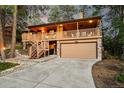 Inviting two-story home featuring a charming covered porch and a convenient two-car garage at 9416 Mcshane Ct, Parker, CO 80134