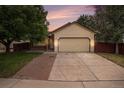 Inviting single-Gathering home with a two-car garage and a brick driveway at sunset at 8401 Sandreed Cir, Parker, CO 80134