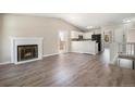 Open-concept living room with fireplace and adjacent kitchen with stainless steel appliances at 8401 Sandreed Cir, Parker, CO 80134