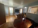 Cozy living room featuring hardwood floors, large screen TV and ample natural light at 11502 E 7Th E Ave, Aurora, CO 80010