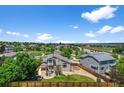 An aerial view of the home showcasing its landscaped backyard, cozy deck, and surrounding neighborhood at 16863 Trail View Cir, Parker, CO 80134