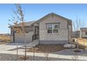 Attractive single-Gathering home with a two-car garage, stone veneer, and a well-manicured lawn at 22036 E 39Th Pl, Aurora, CO 80019