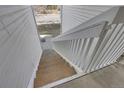 Exterior wood staircase with white railings and stone landing providing access to upper-level apartments at 14473 E Jewell Ave # 202, Aurora, CO 80012