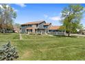 Charming home with well-manicured lawn, mature trees, and inviting curb appeal at 8408 Everett Way # B, Arvada, CO 80005