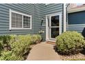 Inviting front entrance with a well-lit walkway and neatly maintained landscaping at 8408 Everett Way # B, Arvada, CO 80005